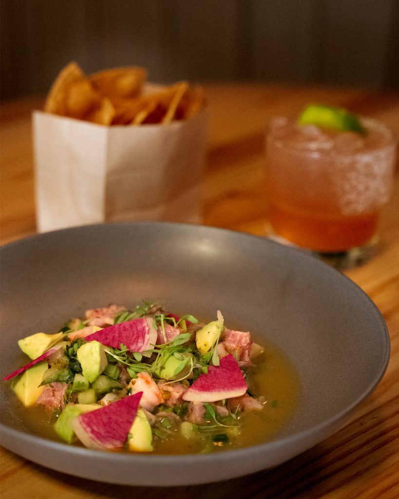 Bowl of the colourful Birdies Ceviche served alongside other dishes from Birdies Eats and Drinks