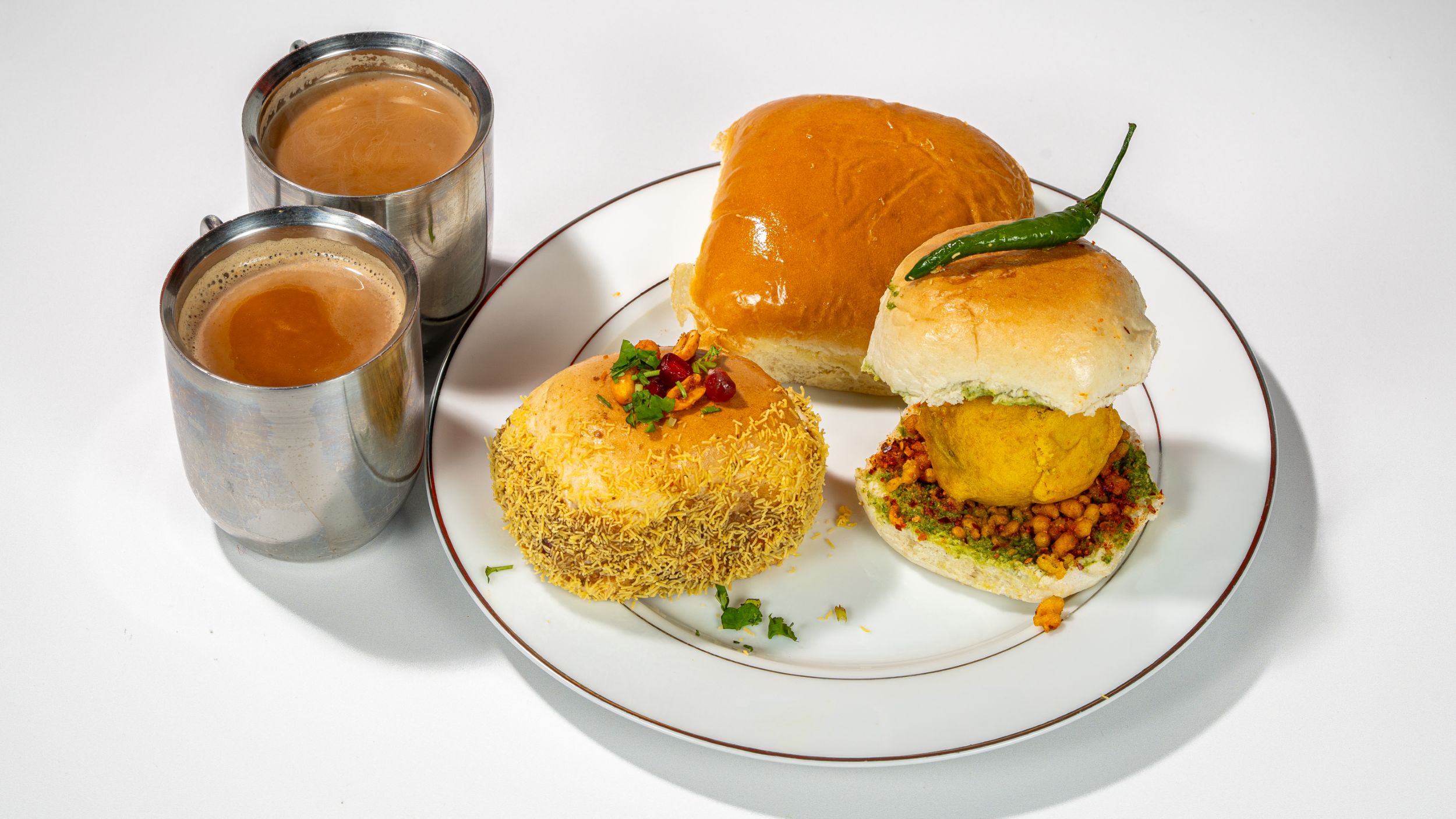 2 chai teas and 3 buns on a tray