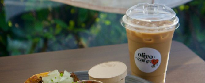 plate with three tacos, condiments and an iced coffee