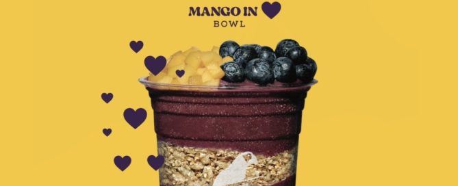 multi-coloured and layered drink on a yellow background