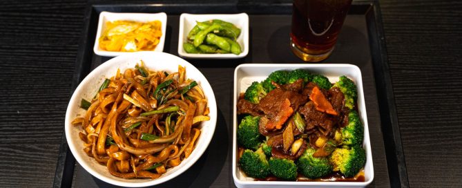 Broccoli beef alongside noodles and side dishes from MYST