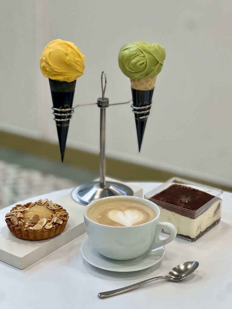 Latte coffee, two gelato cones, and two pastry desserts
