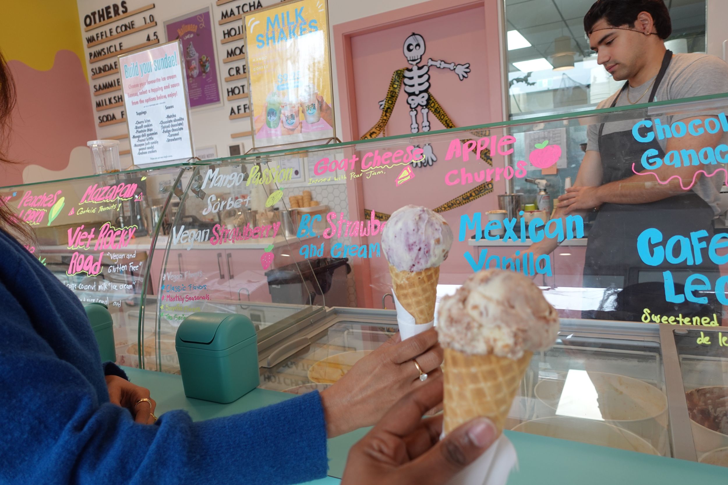 Ice cream shop with a person holding ice cream cones