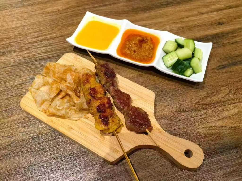 Image of chicken and beef skewers with roti bread