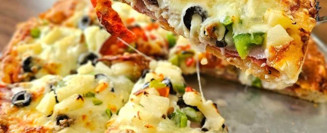 pizza on silver tray on a table