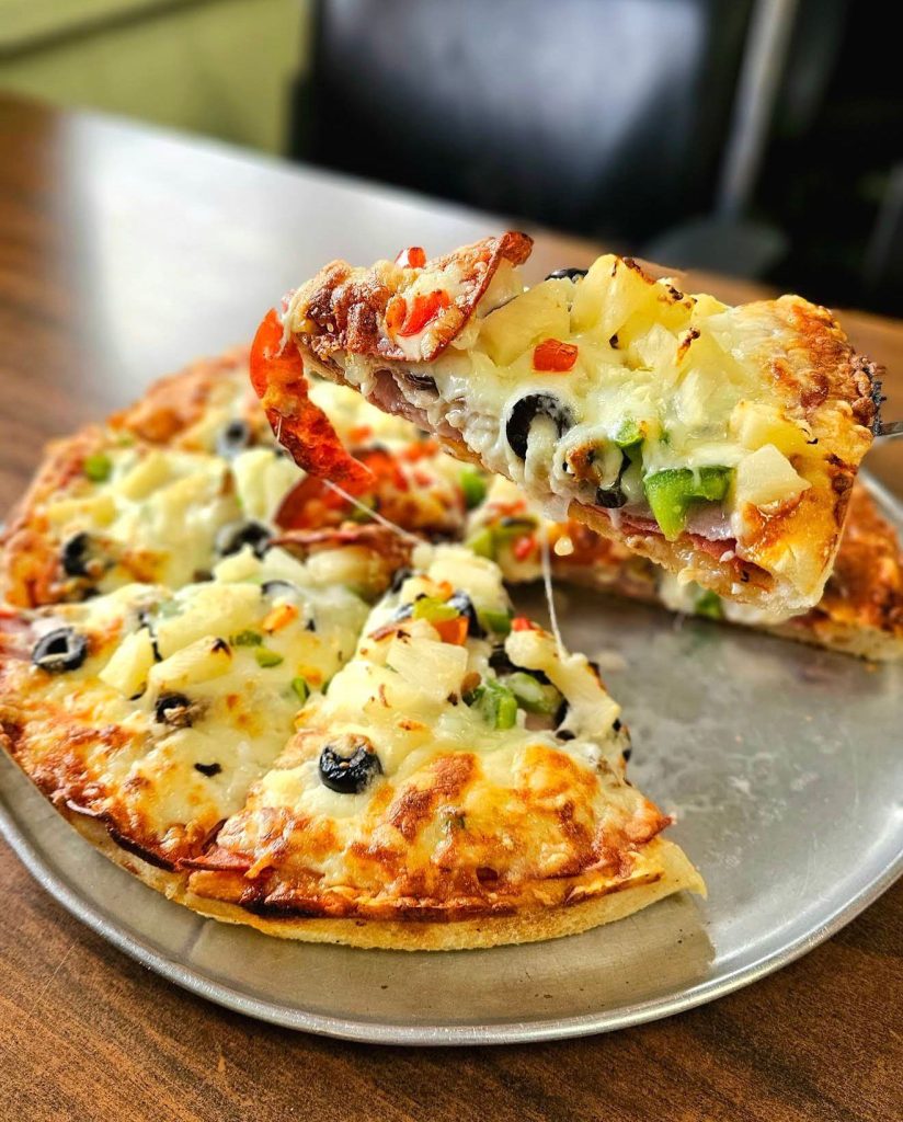 pizza on silver tray on a table